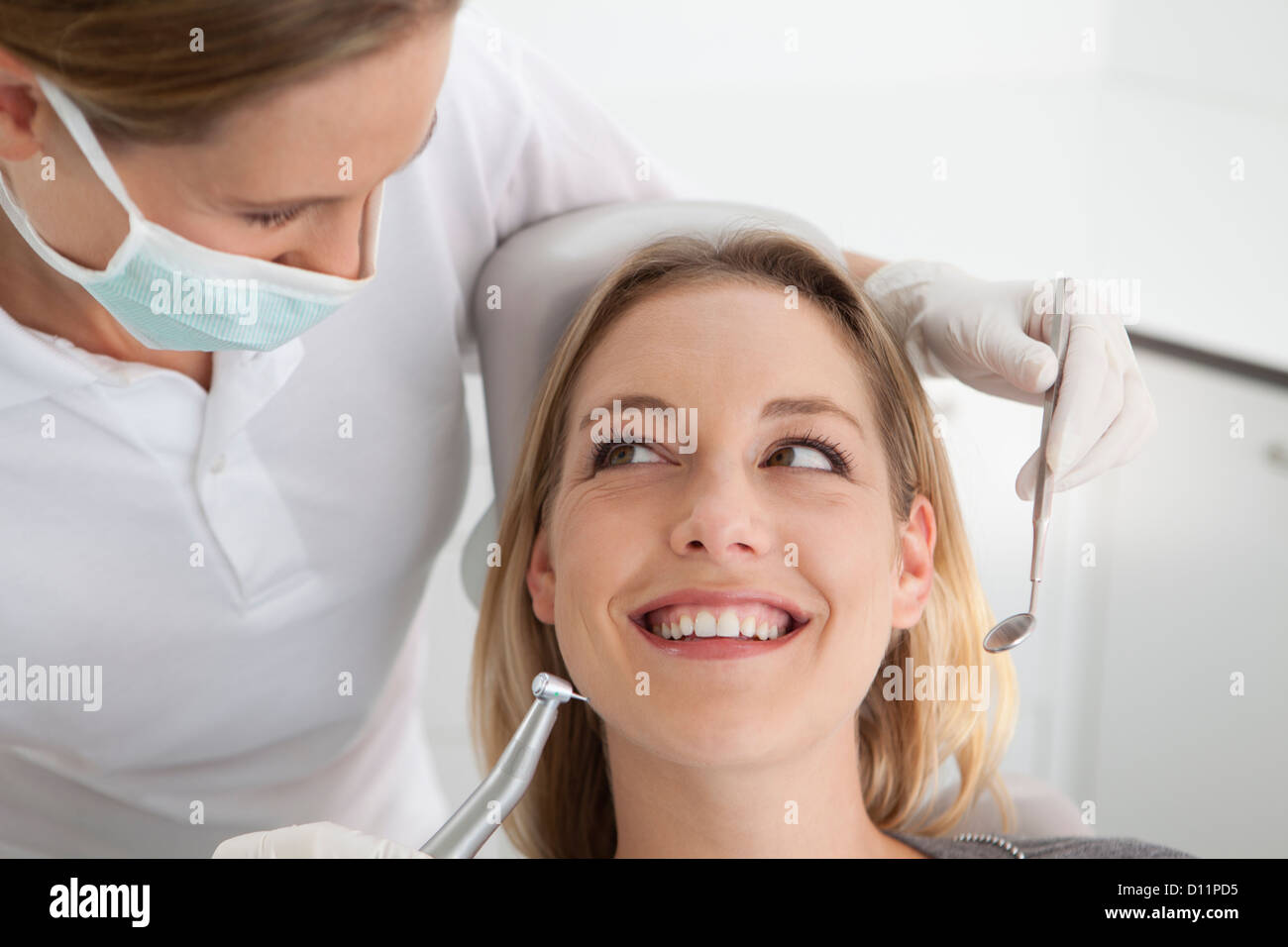 Germany, Young woman getting her teeth examined by dentist Stock Photo