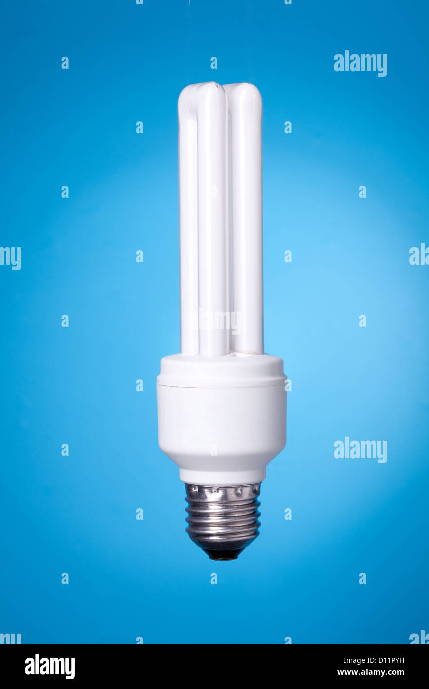 Energy saving lamp on blue gradient background Stock Photo - Alamy