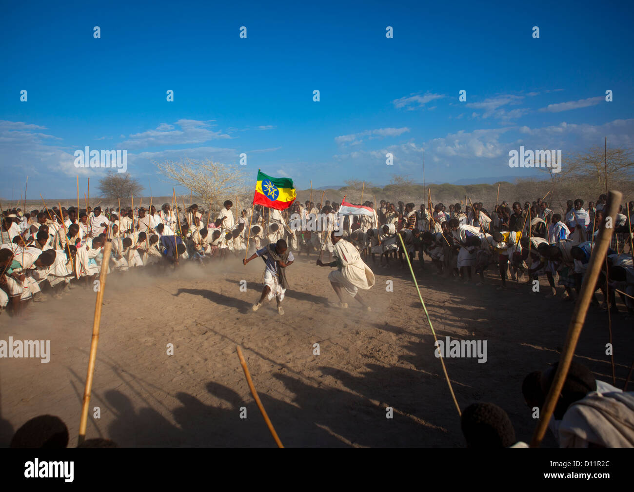 Karrayyu Tribe Man Carrying The Ethiopian Flag During Choreographed Stick Fighting Dance, Gadaaa Ceremony, Metahara, Ethiopia Stock Photo