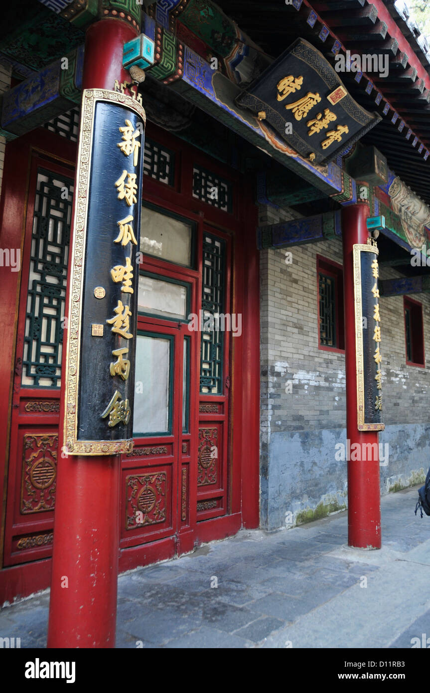 Red Pillars And Facade On A Building With Gold Chinese Characters