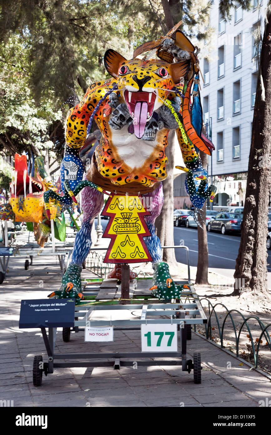 colorful fantastical papier mache jaguar demon creature displayed in median park of Avenida
