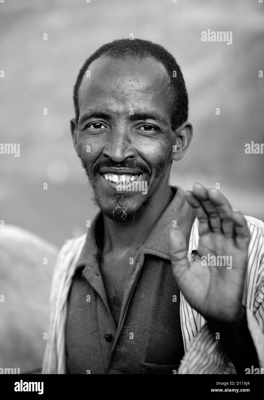 Black And White Portrait Of A Man With Toothy Smile Waving At Camera, Dire Dawa, Ethiopia Stock Photo