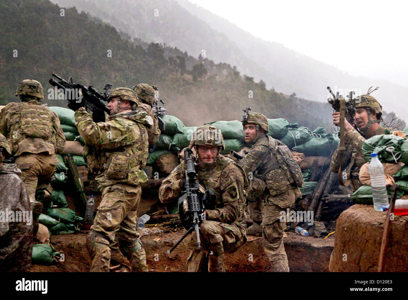 US Soldiers return fire during a firefight with Taliban forces in Barawala Kalay Valley March 31, 2011 in Kunar province, Afghanistan. Stock Photo