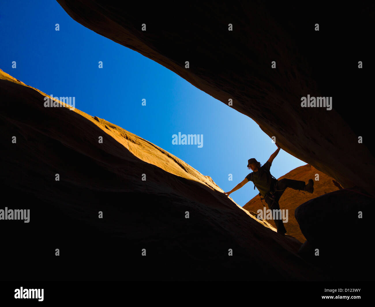 A Male Athlete Exploring Utah Slot Canyons; Hanksville Utah United States Of America Stock Photo
