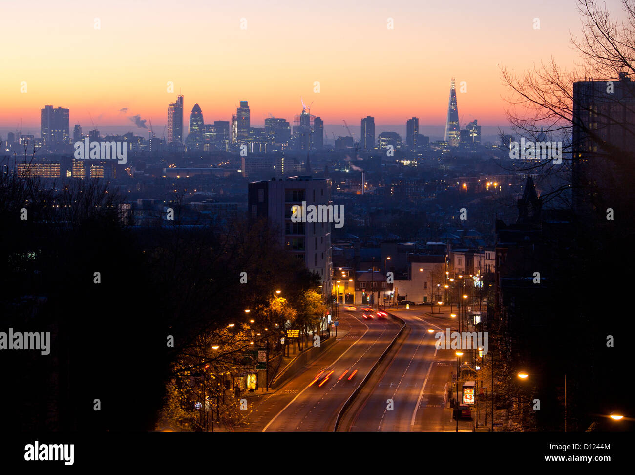 London city skyline from Archway bridge at dawn Archway Road in foreground London England UK Stock Photo