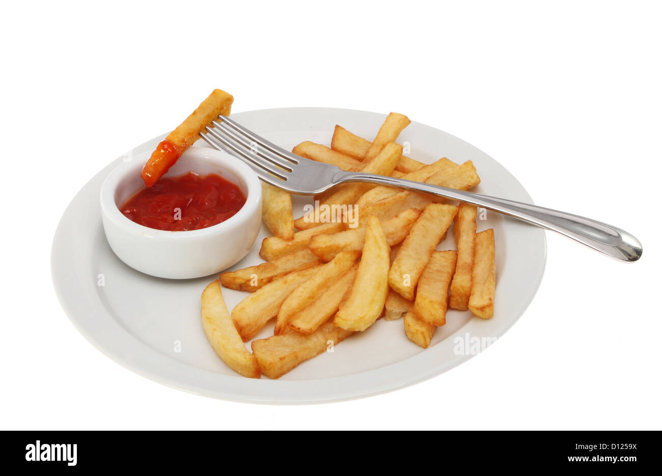 Potato chips on a plate with a fork and a ramekin of tomato ketchup isolated against white Stock Photo