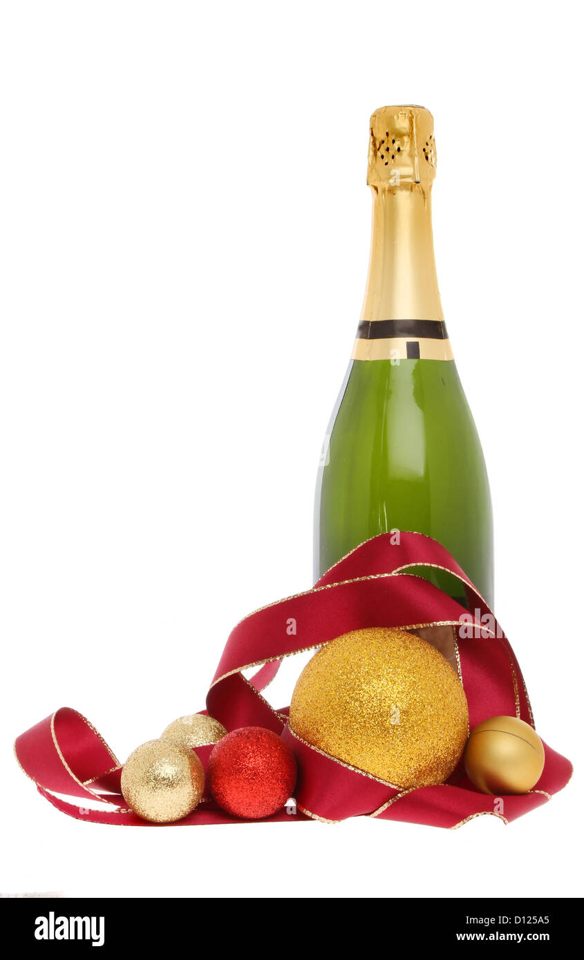 Festive champagne champagne bottle surrounded by ribbon and Christmas baubles isolated against white Stock Photo