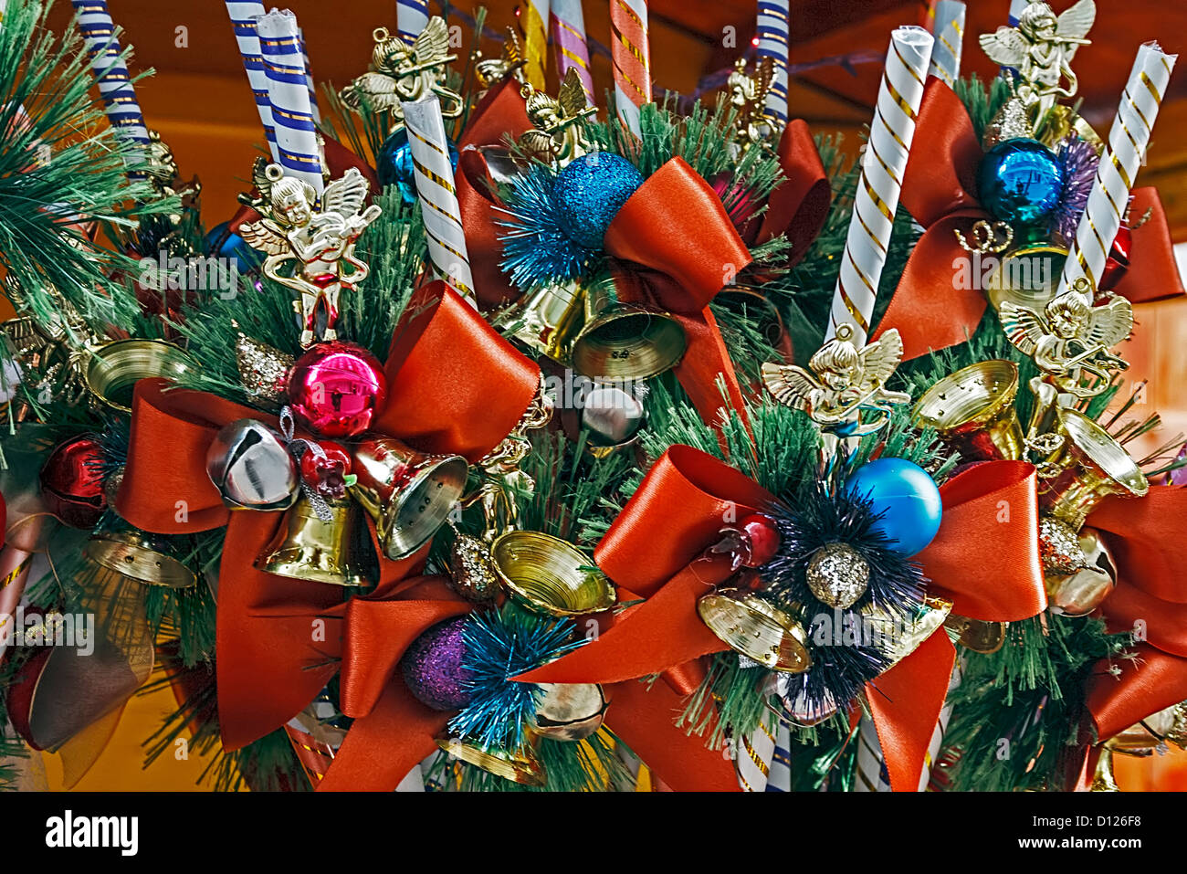 Christmas decorations with pine branches, bows, candles and globes. Stock Photo