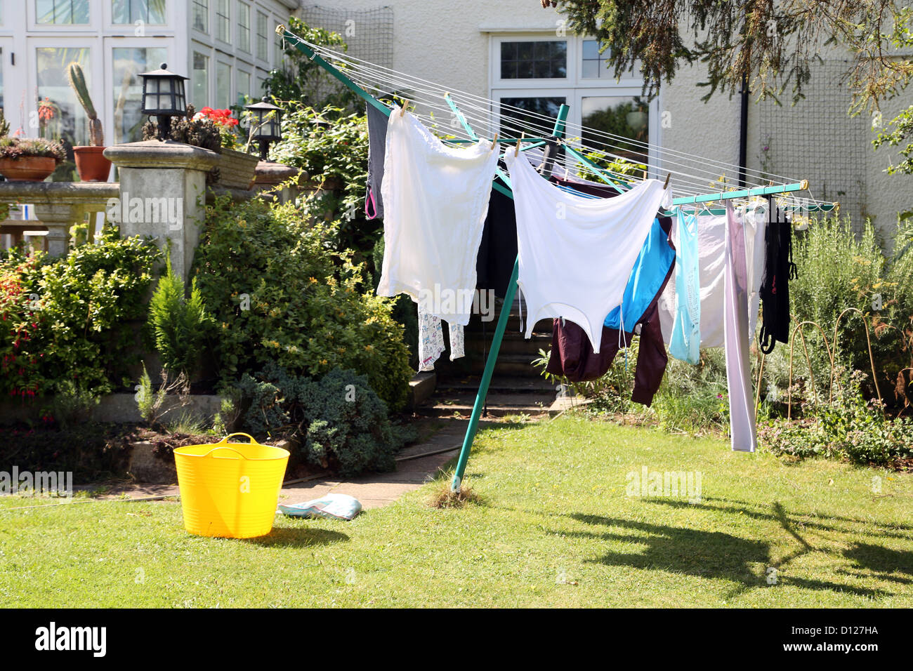 Clothes Drying On Rotary Drier On Sunny Day Surrey England Stock Photo