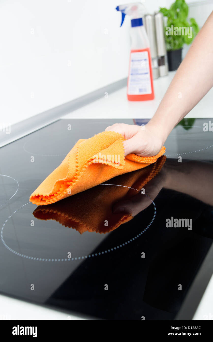 Hand cleaning induction stove Stock Photo Alamy