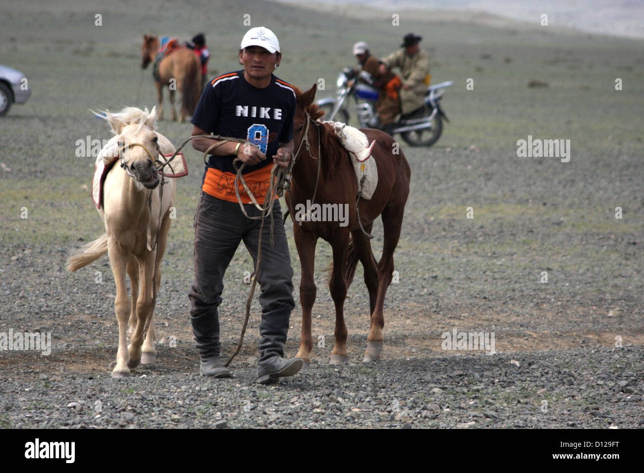 Man leading horses at the Naadam festival horse races, Chandmani Stock Photo