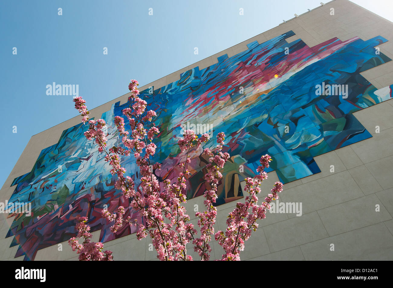 Colourful Abstract Mural On The Side Of A Building With A Cherry Blossom Tree; Edmonton Alberta Canada Stock Photo
