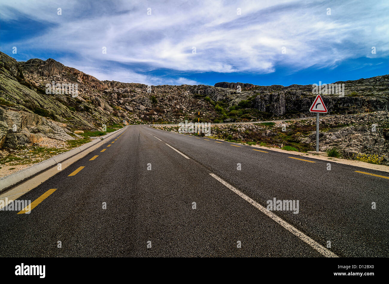 Asphalt road in the mountains and blue sky with clouds Stock Photo - Alamy