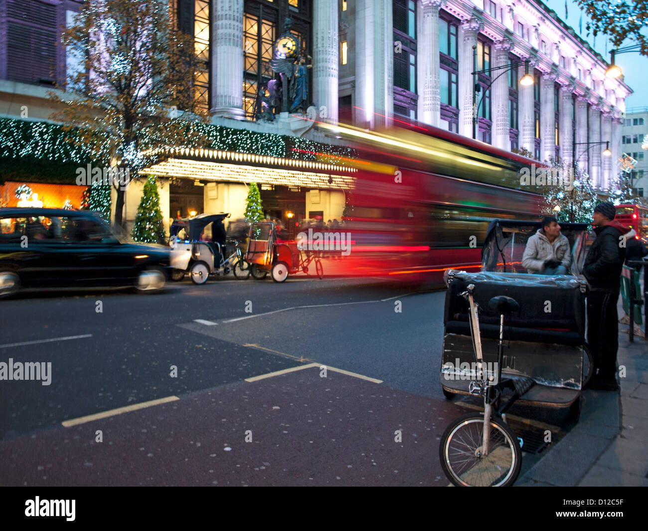 Oxford Street showing Selfridges Department store at night, City of