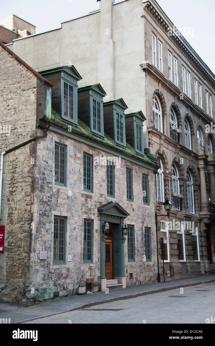 A Stone Building With Wooden Door And Loft Windows; Montreal Quebec