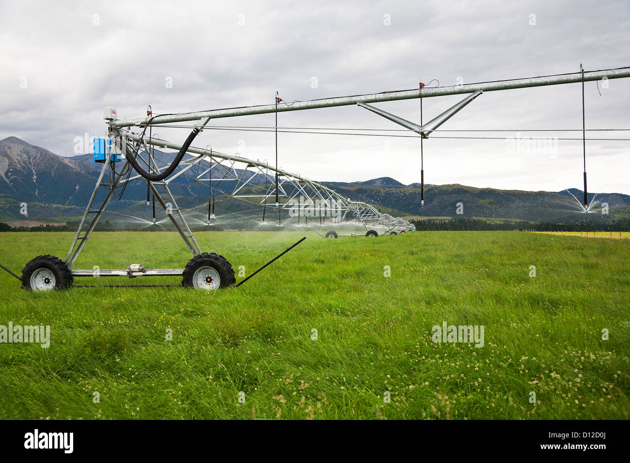Irrigation system working in a field, watering pasture land. Canterbury, South Island, New Zealand. Stock Photo