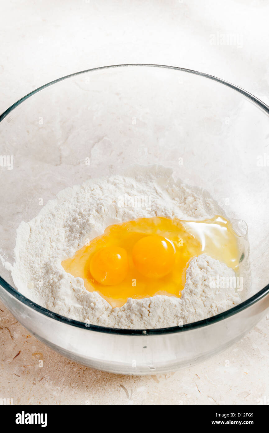 flour and eggs in mixing bowl Stock Photo Alamy