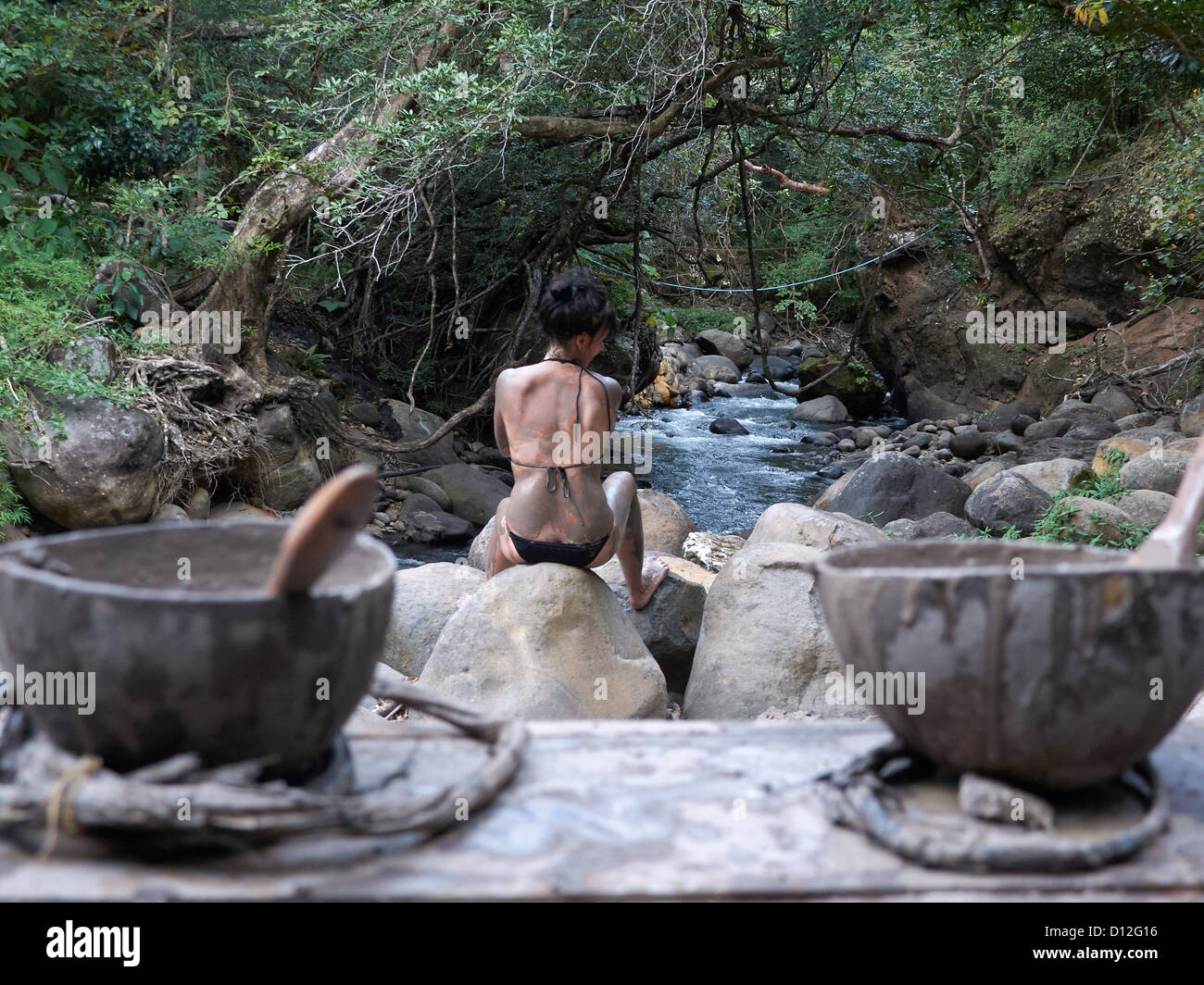 woman with volcanic mineral mud in a outdoor spa; Las Pailas; Ricòn de la Vieja National Park; Costa Rica Stock Photo