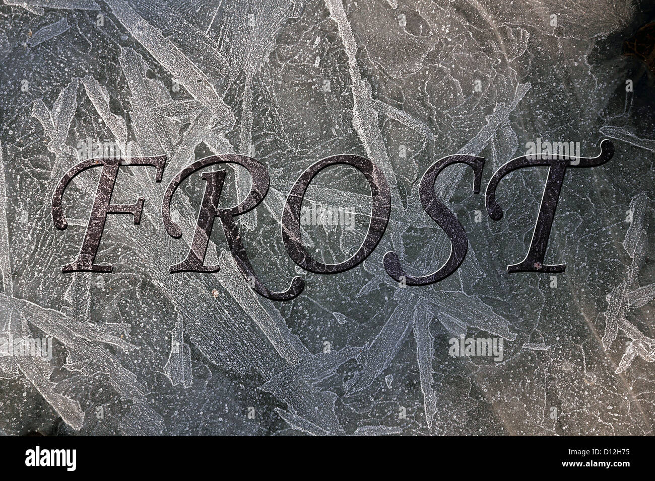 Hoar frost patterns on frozen puddle with embossed lettering added ...