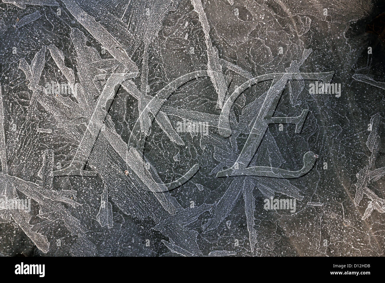 Hoar frost patterns on frozen puddle with embossed lettering added digitally, Leicestershire, UK Stock Photo