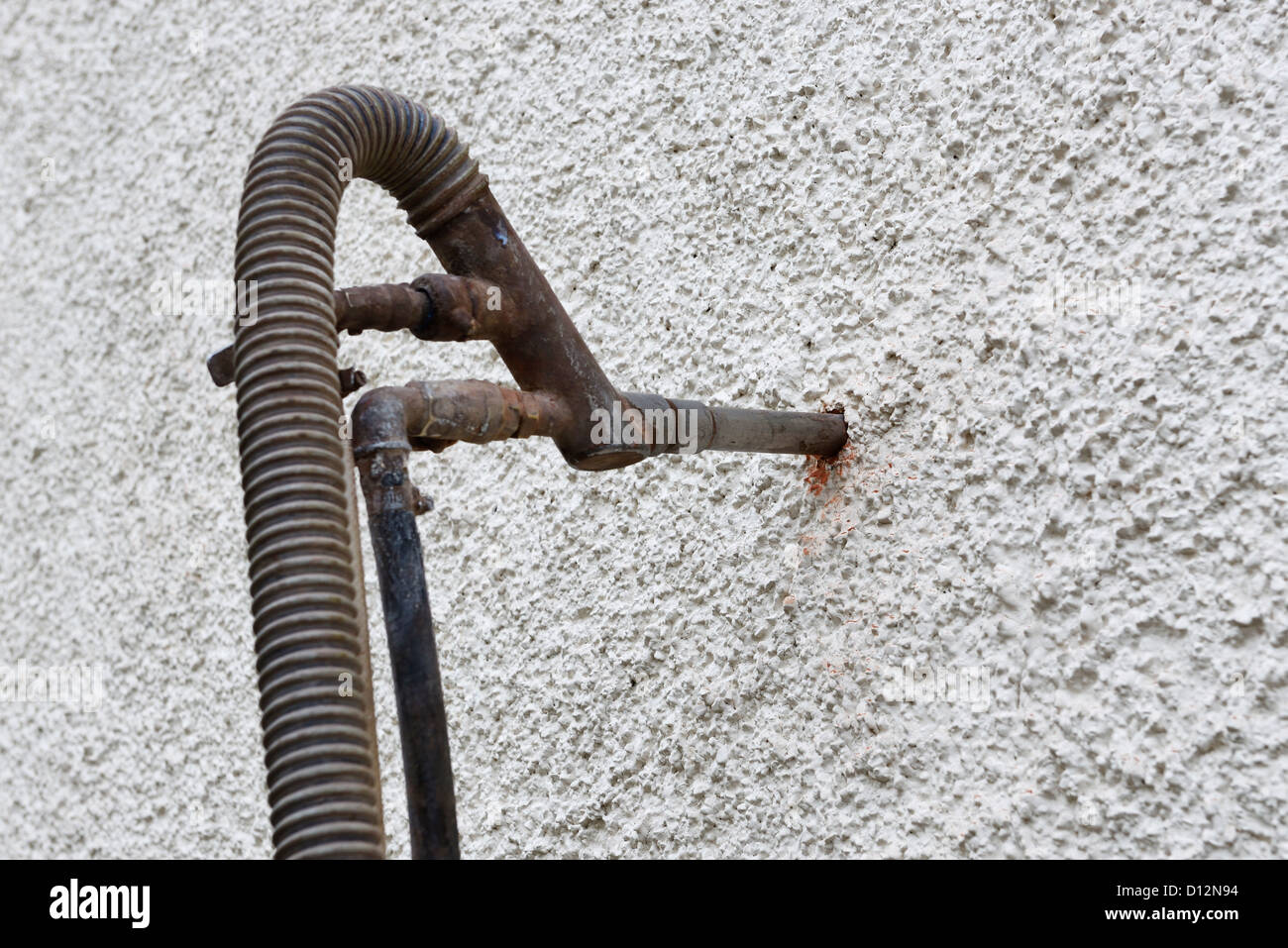 Nozzle injecting cavity wall insulation into a house Stock Photo
