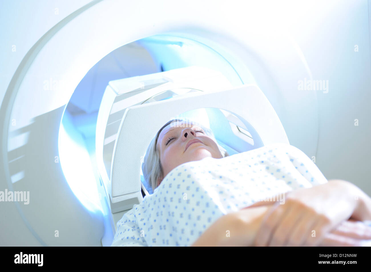Young female hospital patient in MRI scanner Stock Photo