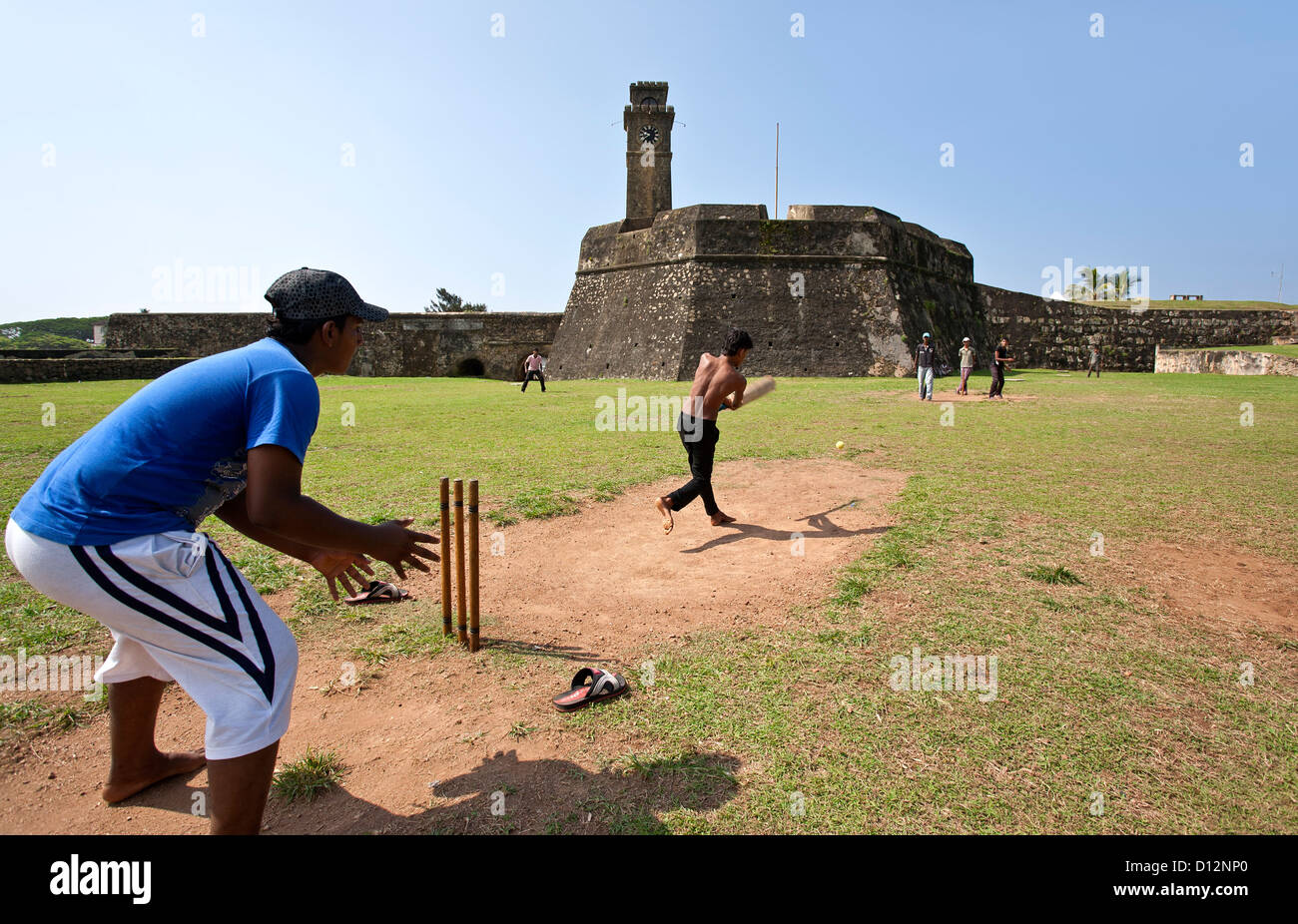 Young men playing cricket. Galle Fort. Sri Lanka Stock Photo