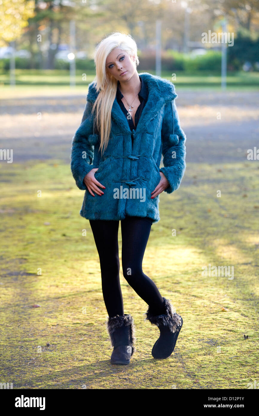 Pretty girl in her 20's standing alone looking towards camera. Stock Photo