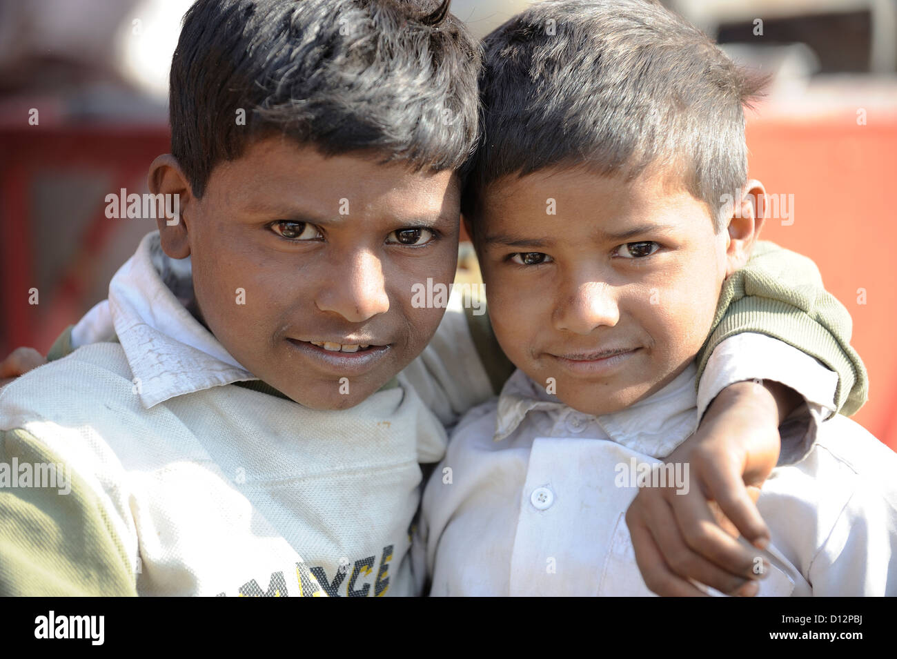 Portrait of young brothers with arms around looking at you Stock Photo
