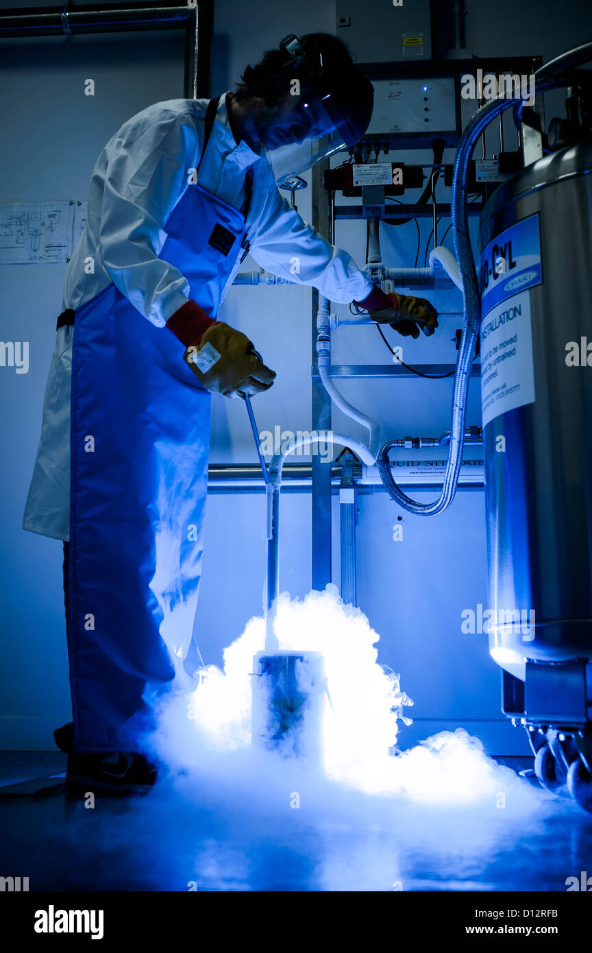Scientist transfers liquid nitrogen from one container to another in