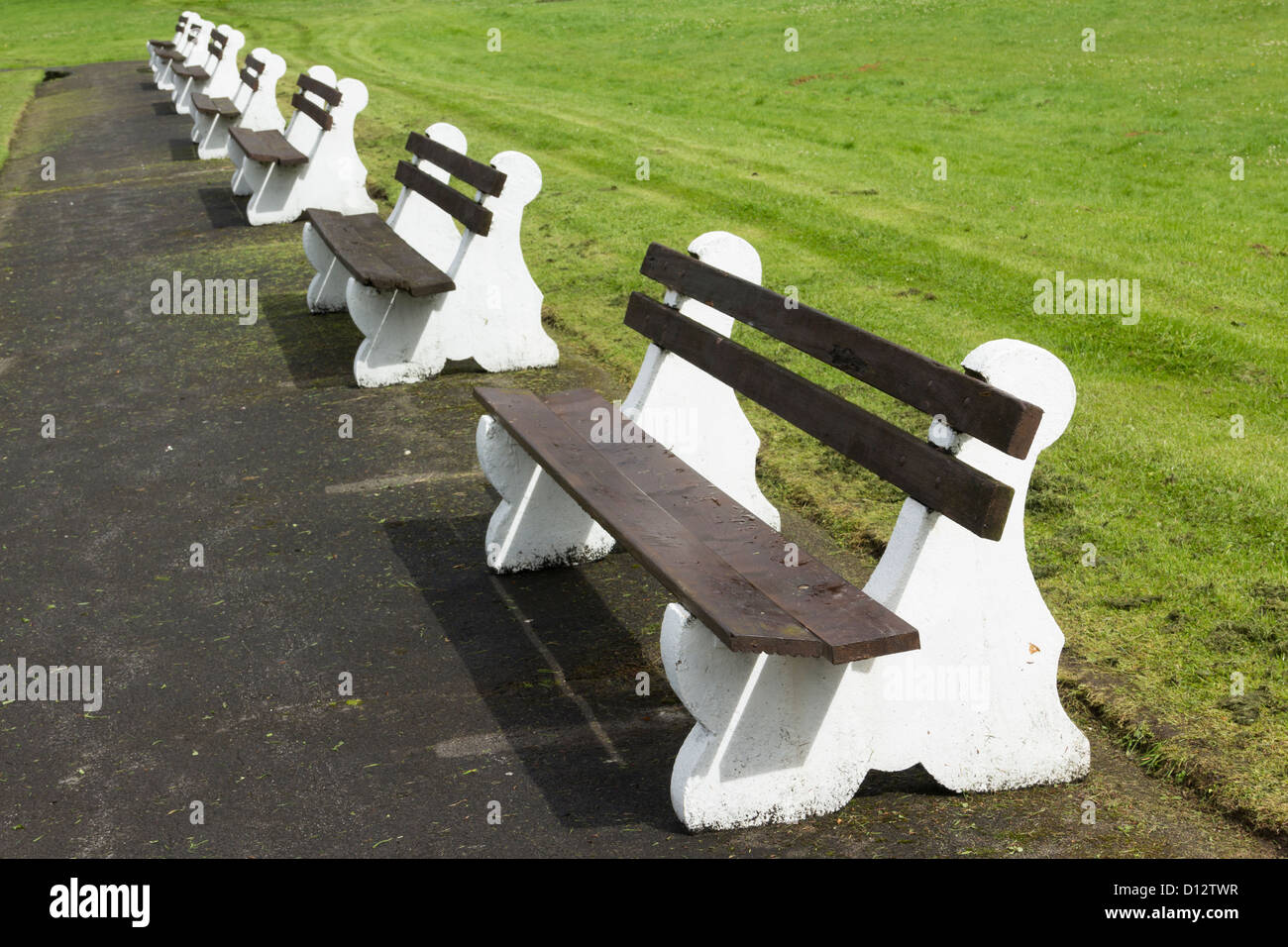 Crown bowling green surrounded by bench seats at Moss Bank Park Bolton. Nobody playing. Stock Photo