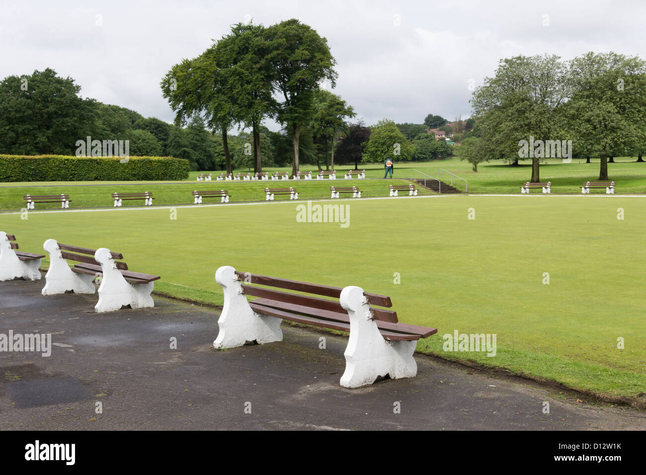 Crown bowling green surrounded by bench seats at Moss Bank Park Bolton. Nobody playing. Stock Photo
