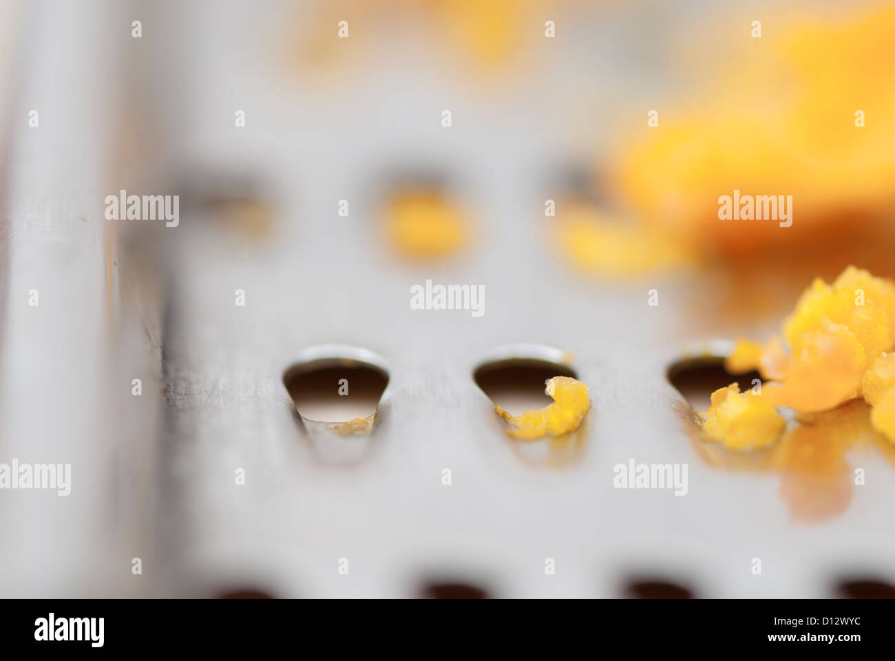 Grater and citrus zest on wooden kitchen surface. Stock Photo