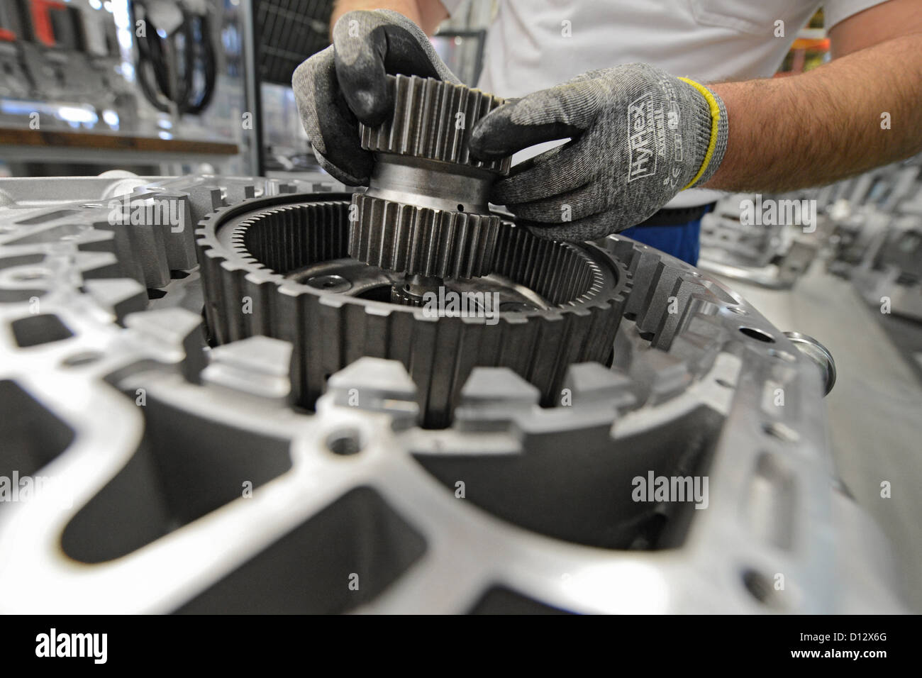 An employee installs a gearbox at the ZF Friedrichshafen AG factory in Friedrichshafen, Germany, 29 November 2012. Photo: Felix Kaestle Stock Photo