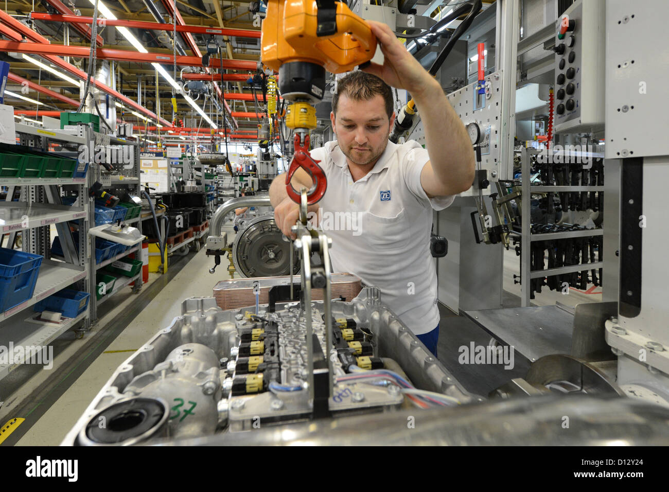 Employee Ilhami Tekin installs a gearbox at the ZF Friedrichshafen AG factory in Friedrichshafen, Germany, 29 November 2012. Photo: Felix Kaestle Stock Photo