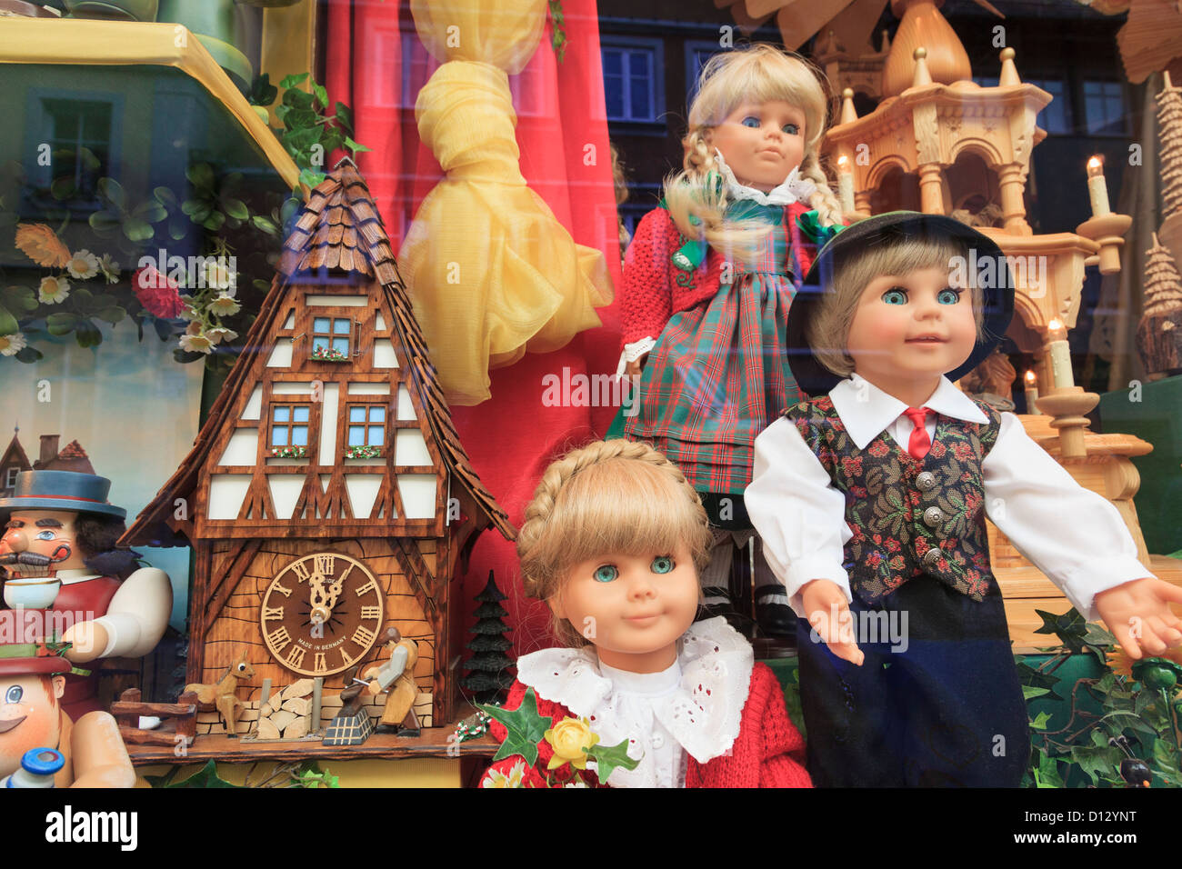 Shop window display of dolls in traditional costume looking through glass. Rothenburg Ob der Tauber, Franconia, Bavaria, Germany Stock Photo