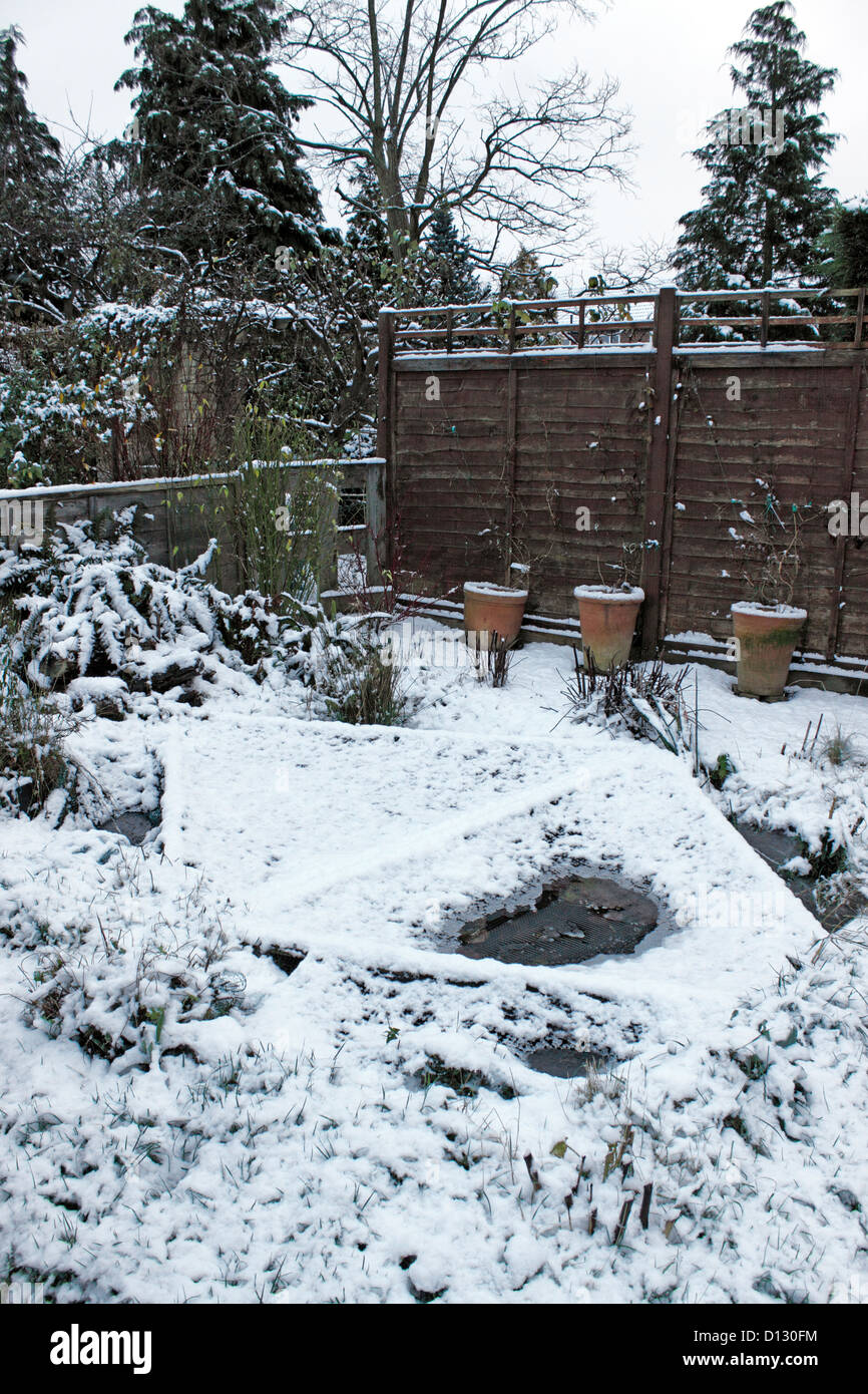 FROZEN GARDEN FISHPOND. UK. Stock Photo