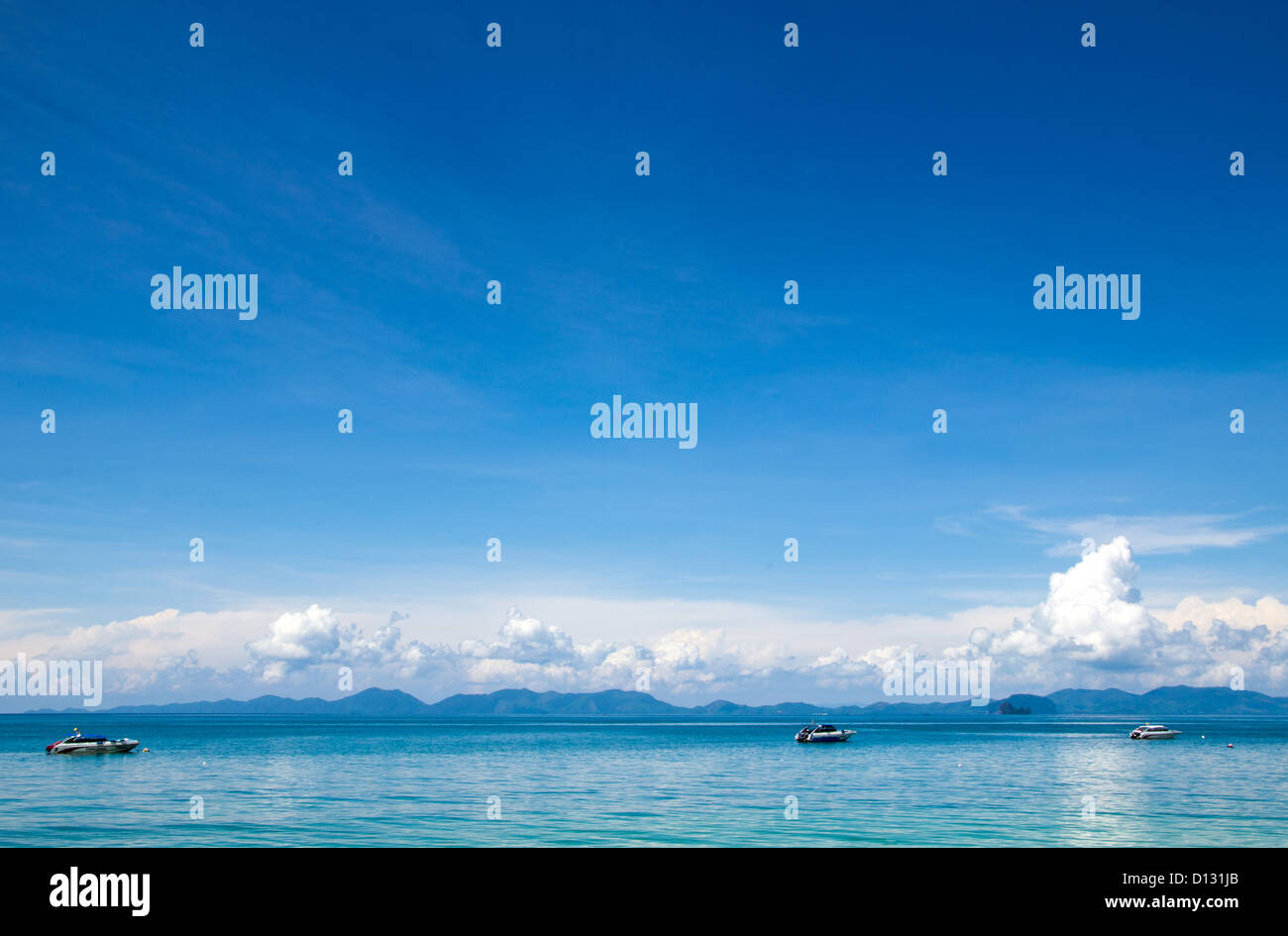 cloudy blue sky above a surface of the sea Stock Photo