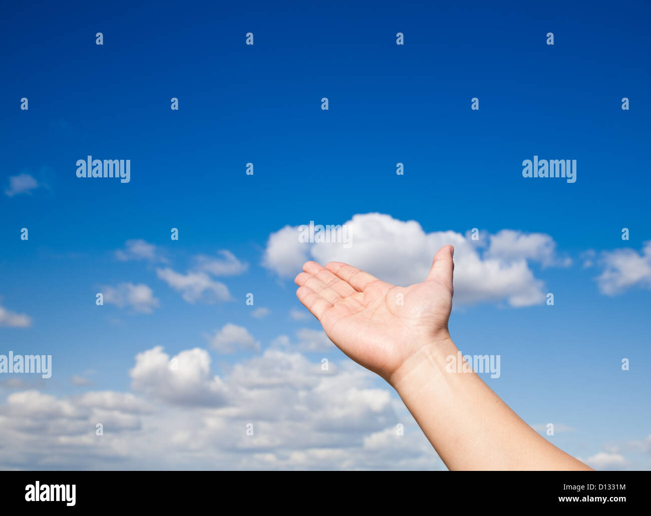 hand reaching up to the blue sky Stock Photo