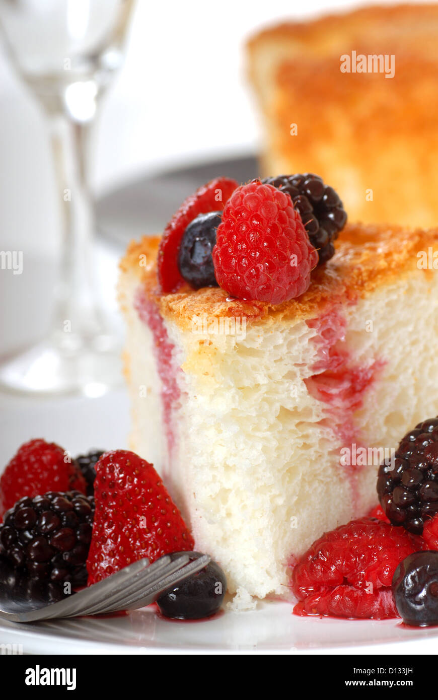 Slice of freshly baked Angel Food Cake with fresh fruit Stock Photo