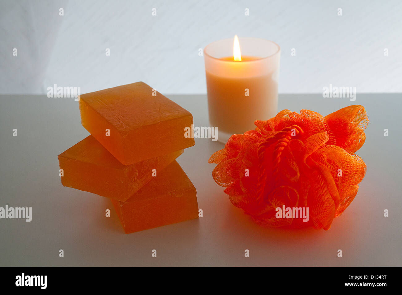 Soap, sponge and lit up candle. Stock Photo
