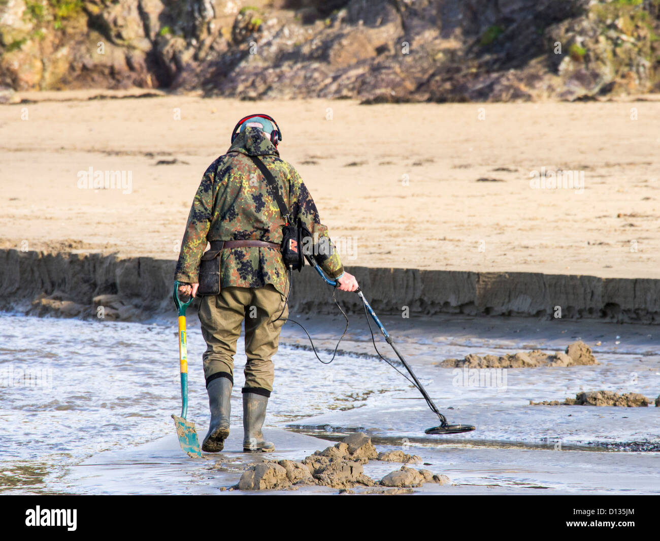 A man with a metal detector on Polzeath beach, Cornwall, UK Stock Photo Alamy