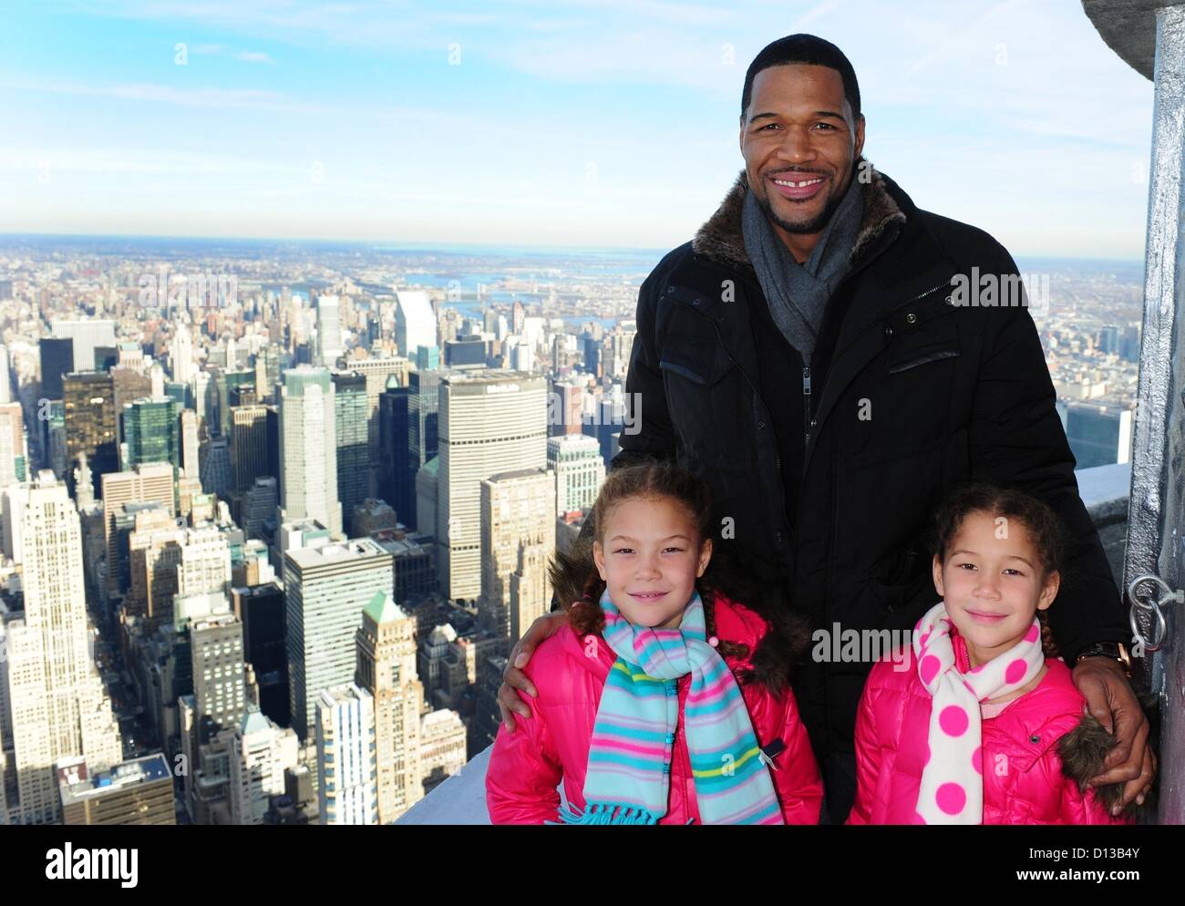 Dec. 6, 2012 - Manhattan, New York, U.S. - MICHAEL STRAHAN, with daughters ISABELLA AND SOPHIA, lights the Empire State Building green and tour the 86th floor Observatory and 103rd floor parapet in celebration of St. Jude Children's Research Hospital ''Thanks and Giving'' campaign, Thursday, December 6, 2012. (Credit Image: © Bryan Smith/ZUMAPRESS.com) Stock Photo