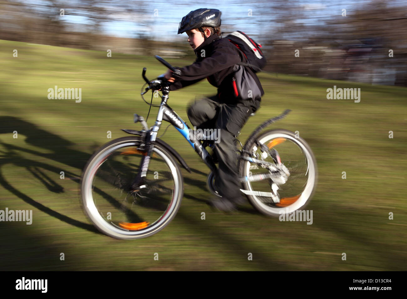 Berlin, Germany, boy riding a bike on a meadow Stock Photo Alamy