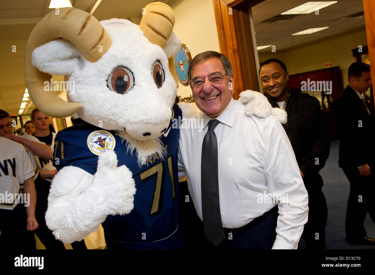 US Secretary of Defense Leon Panetta poses with Bill the Goat, the US Naval Academy Midshipmen mascot during a pep rally held in the halls of the Pentagon December 6, 2012. The 113th Army Navy football game will be held this Saturday in Philadelphia. Stock Photo