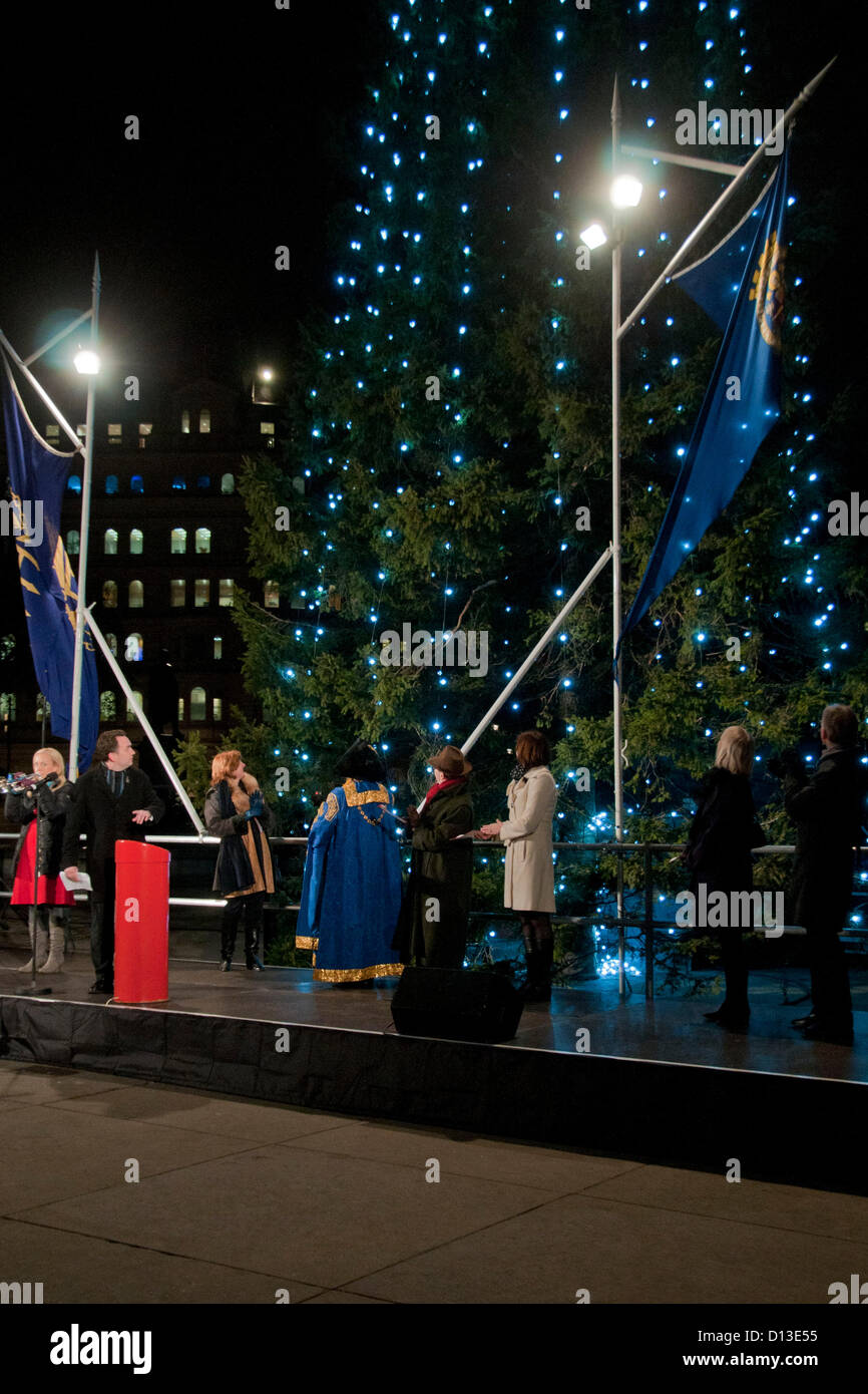 London, UK. 06/12/12. The Governing Mayor of Oslo, Mr Stian Berger Rosland presses the button to light up the tree as  he attends the Lighting-up Ceremony of the Oslo Christmas Tree in Trafalgar Square. Stock Photo