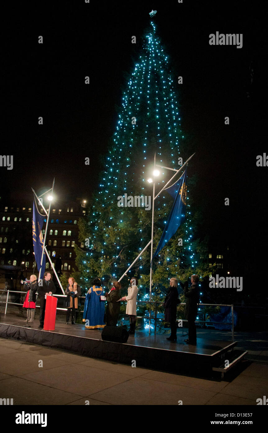 London, UK. 06/12/12. The Governing Mayor of Oslo, Mr Stian Berger Rosland presses the button to light up the tree as  he attends the Lighting-up Ceremony of the Oslo Christmas Tree in Trafalgar Square. Stock Photo