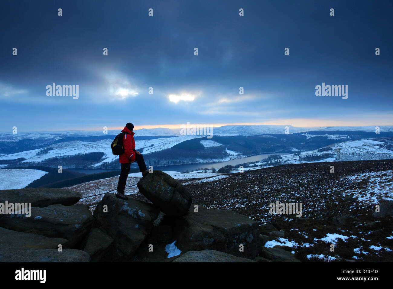 Adult male walker overlooking Ladybower reservoir, Wintertime, Upper Derwent Valley, Peak District National Park, Derbyshire Stock Photo