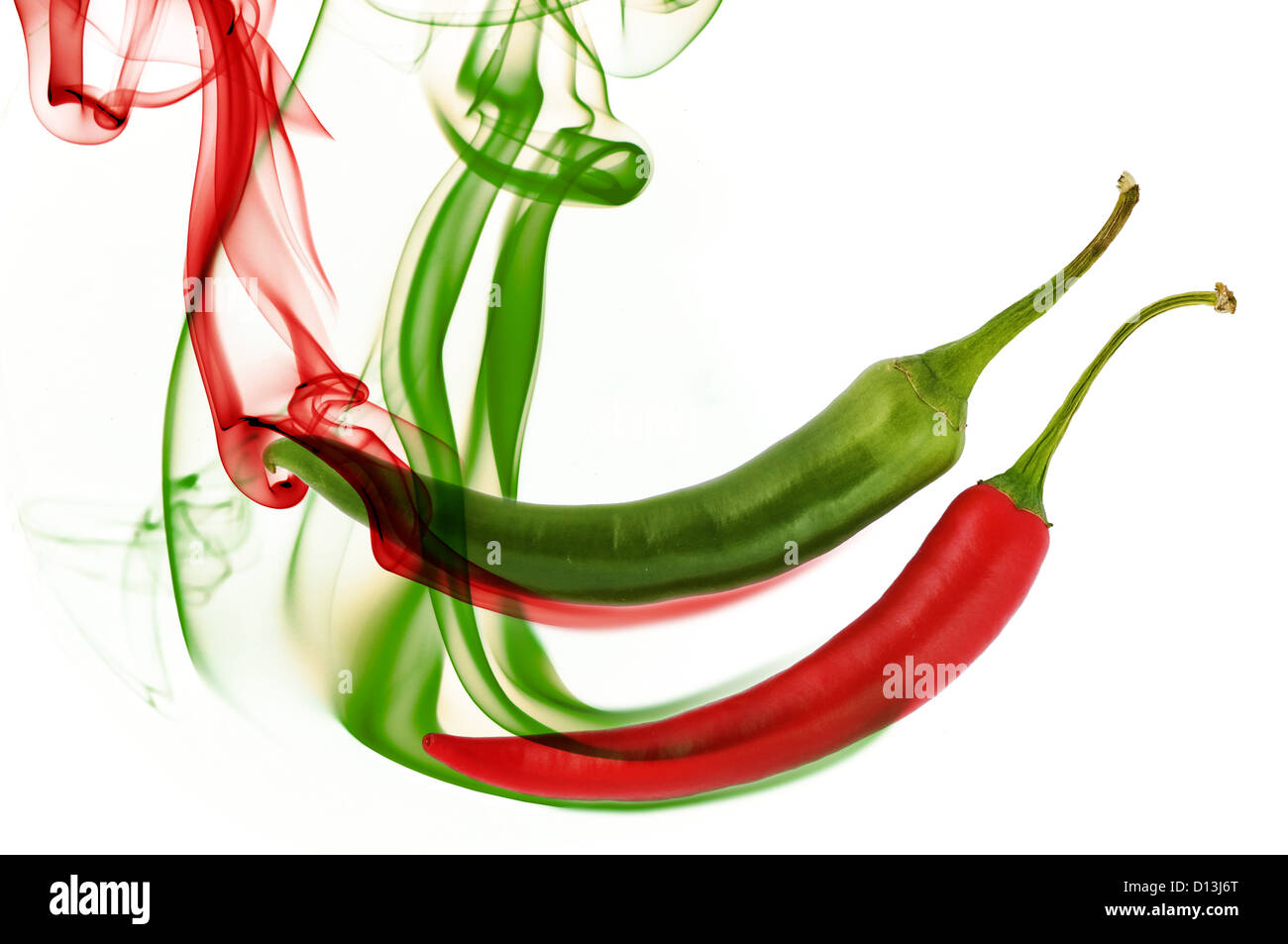 red and green hot chili pepper with color smoke on white Stock Photo