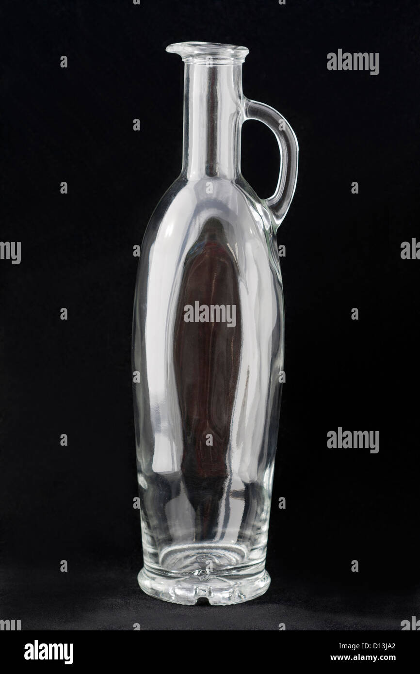 Empty glass bottle against black background Stock Photo